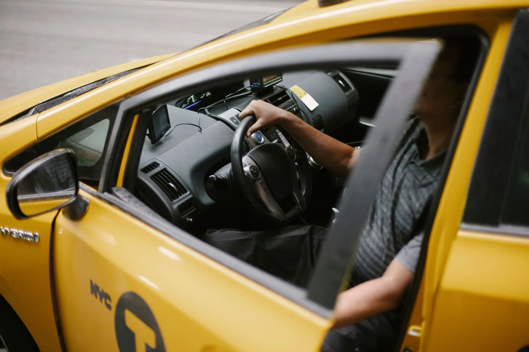 Representative taxi driver seated inside a cab