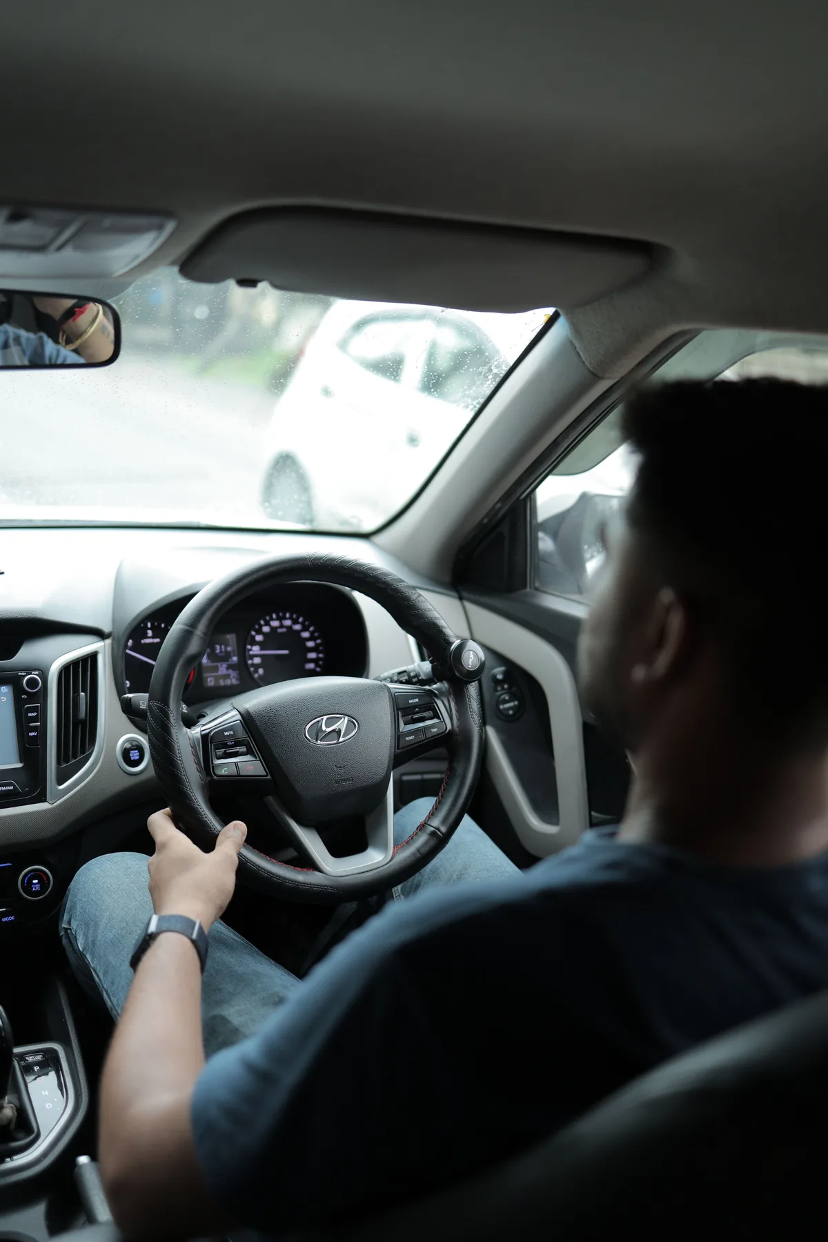 Representative driver inside a modern car during city travel