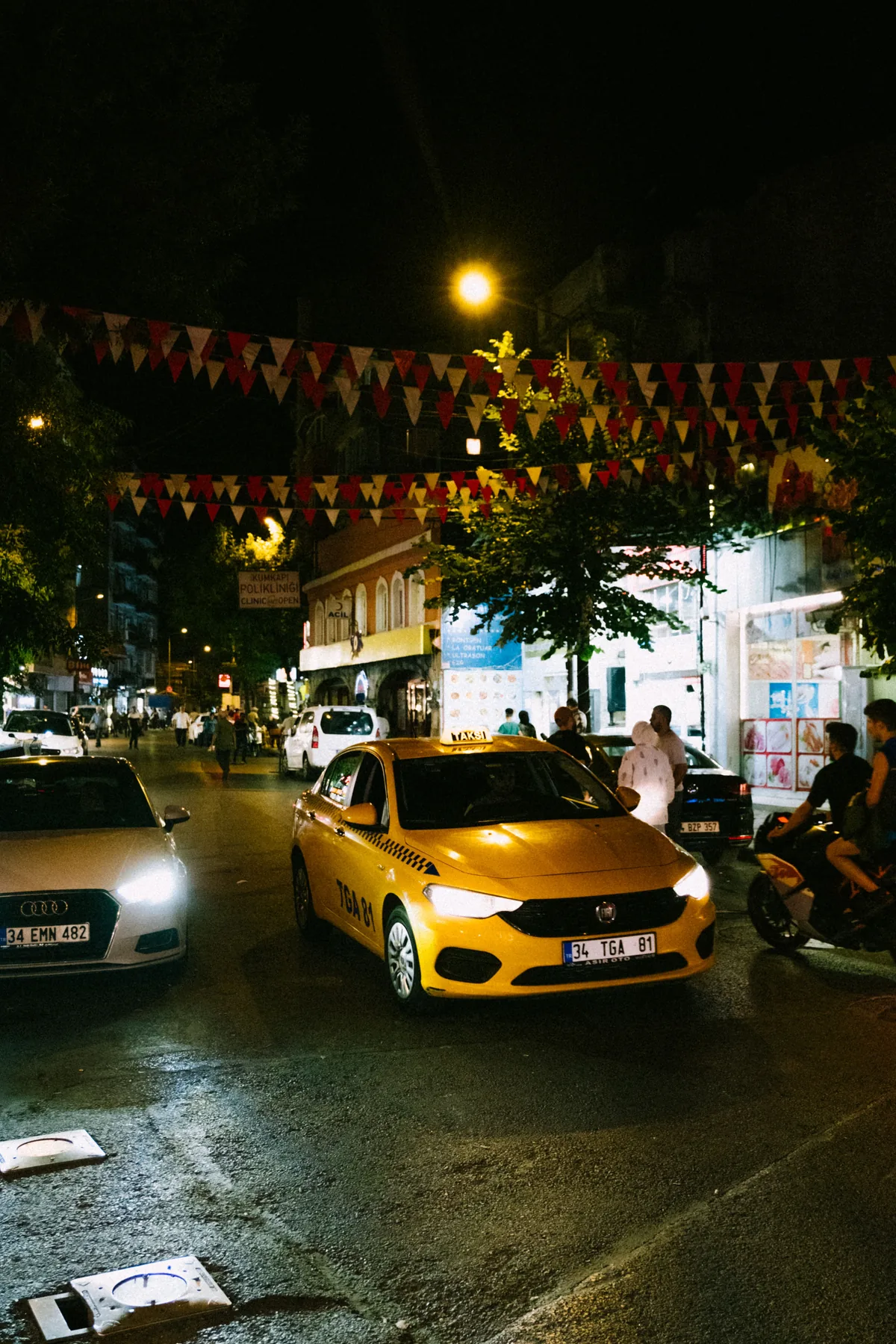 Representative taxi driving through a city street at night